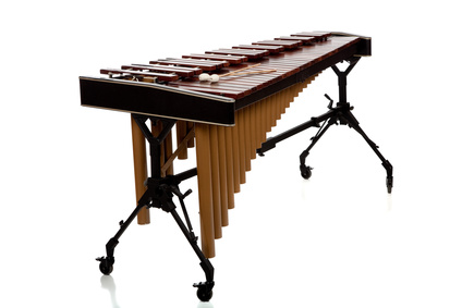A marimba on white with mallets and copy space