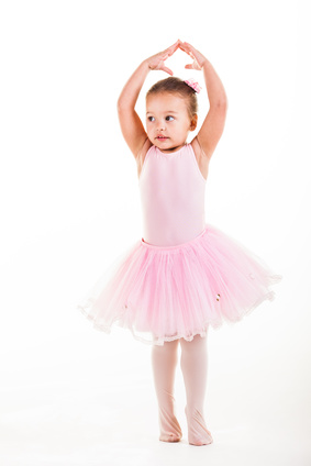 A little pink ballerina in a playful mood in the studio.